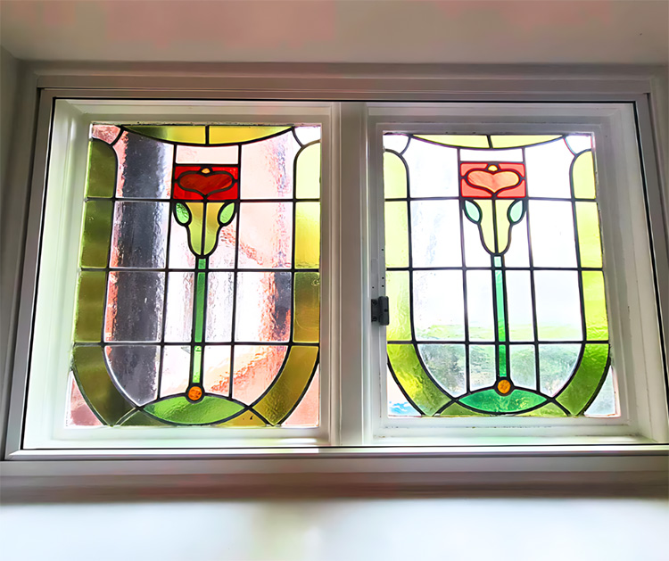 White lift-out secondary glazing panel fitted behind an existing window