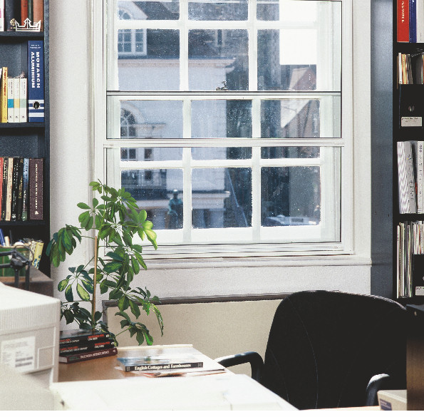 White vertical sliding secondary glazing fitted behind an existing sash window